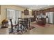 Eat-in kitchen with dark wood cabinets, stainless appliances and dining table with seating for four at 267 Dando St, Garner, NC 27529