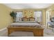 Bedroom with warm paint, multiple windows with curtains, television, dresser, and nightstand at 267 Dando St, Garner, NC 27529