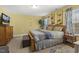 Bedroom with warm paint, multiple windows with curtains, television, dresser, and nightstand at 267 Dando St, Garner, NC 27529