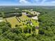 Extensive acreage featuring a charming home, a detached garage, and picturesque fields surrounded by dense woodlands at 280 Phillips Rd, Selma, NC 27576