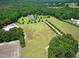 Estate aerial view showcases the home, surrounding greenery, and spacious lawns, offering privacy and space at 280 Phillips Rd, Selma, NC 27576
