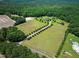 Expansive aerial view of property with long driveway, green fields, mature trees, and secluded home at 280 Phillips Rd, Selma, NC 27576