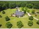Beautiful estate featuring a well-maintained home, lush lawns, mature trees, and a detached garage/workshop at 280 Phillips Rd, Selma, NC 27576