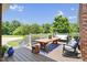 Large back deck with furniture overlooks a lush green backyard and blue skies at 280 Phillips Rd, Selma, NC 27576