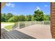 Large back deck with white railings overlooks a lush green backyard and blue skies at 280 Phillips Rd, Selma, NC 27576