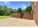 Brick patio and steps surrounded by green trees and bushes at 280 Phillips Rd, Selma, NC 27576