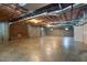 Large unfinished basement with concrete floor, brick fireplace, and cinder block wall at 280 Phillips Rd, Selma, NC 27576