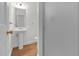 Bright bathroom features a pedestal sink, framed mirror, and a shower stall at 280 Phillips Rd, Selma, NC 27576
