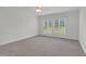 Bedroom with neutral carpet, light walls, and large windows offering plenty of natural light at 280 Phillips Rd, Selma, NC 27576