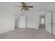Bright bedroom showcasing multiple doors, neutral carpet and an overhead ceiling fan at 280 Phillips Rd, Selma, NC 27576