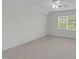 Bright bedroom offering soft carpet, a ceiling fan, and a window for natural light at 280 Phillips Rd, Selma, NC 27576