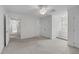 Large bedroom with neutral carpet, a ceiling fan, and access to other rooms at 280 Phillips Rd, Selma, NC 27576
