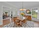 Bright dining room features hardwood floors, a modern chandelier and an open floor plan at 280 Phillips Rd, Selma, NC 27576