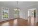 Elegant dining room featuring hardwood floors, modern chandelier, and ample natural light at 280 Phillips Rd, Selma, NC 27576