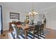 Dining room with hardwood floors, a modern chandelier and open design to other rooms at 280 Phillips Rd, Selma, NC 27576