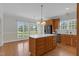 Bright kitchen with island, featuring wooden cabinets and stainless steel appliances at 280 Phillips Rd, Selma, NC 27576