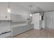 Open concept kitchen featuring gray cabinets, laminate floors and modern lighting at 280 Phillips Rd, Selma, NC 27576