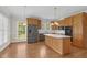 Bright kitchen featuring stainless steel appliances, wood cabinets, and a kitchen island at 280 Phillips Rd, Selma, NC 27576
