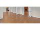 Expansive living area with hardwood floors leading to a brick fireplace and adjoining rooms at 280 Phillips Rd, Selma, NC 27576