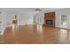 Bright living room with hardwood floors, fireplace, and open doorways, providing a comfortable and inviting atmosphere at 280 Phillips Rd, Selma, NC 27576