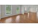 Sunlit living room with hardwood floors, neutral paint, and large windows, creating a bright and airy space at 280 Phillips Rd, Selma, NC 27576