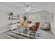 Comfortable home office with a ceiling fan, built-in shelves, and a large desk and chairs at 280 Phillips Rd, Selma, NC 27576