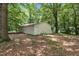 Exterior of a one-story outbuilding in the rear of property among the trees at 280 Phillips Rd, Selma, NC 27576