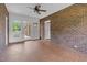 Sunroom features brick walls, tile floors, ceiling fan, and views of the back yard at 280 Phillips Rd, Selma, NC 27576