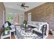 Staged sunroom with brick walls, tile floors, ceiling fan, and exterior views at 280 Phillips Rd, Selma, NC 27576