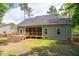 Landscaped backyard with a screened-in porch, wooden deck, and lush green grass at 293 Carolina Oaks Ave, Smithfield, NC 27577