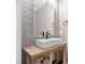 Stylish bathroom with a modern sink, rustic wooden vanity, and wood-paneled walls at 293 Carolina Oaks Ave, Smithfield, NC 27577