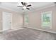 Bright bedroom with a ceiling fan and two windows at 293 Carolina Oaks Ave, Smithfield, NC 27577