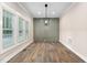 Dining room with hardwood floors, wainscoting, modern light fixture, and ample natural light at 293 Carolina Oaks Ave, Smithfield, NC 27577