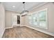 Spacious dining room with hardwood floors, trim work, and large windows offering natural light at 293 Carolina Oaks Ave, Smithfield, NC 27577