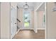 Bright foyer with hardwood floors, a modern light fixture, and access to the staircase at 293 Carolina Oaks Ave, Smithfield, NC 27577