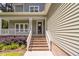 Inviting front entrance with brick steps, white railings, and well-maintained landscaping at 293 Carolina Oaks Ave, Smithfield, NC 27577