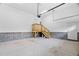 Spacious garage interior featuring block walls, a wooden staircase, and ample storage potential at 293 Carolina Oaks Ave, Smithfield, NC 27577