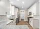 Modern kitchen with white cabinets, granite countertops, stainless steel appliances and subway tile backsplash at 293 Carolina Oaks Ave, Smithfield, NC 27577