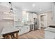 Bright kitchen featuring white cabinets, stainless appliances, granite countertops, and a rustic wood island at 293 Carolina Oaks Ave, Smithfield, NC 27577