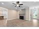Bright living room with hardwood floors, a fireplace, and an open layout with access to the kitchen at 293 Carolina Oaks Ave, Smithfield, NC 27577