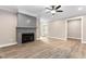 Cozy living room featuring a gray fireplace, hardwood floors, and a ceiling fan at 293 Carolina Oaks Ave, Smithfield, NC 27577