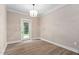 Bright and airy room with wood-look floors and a door leading to the outdoors at 293 Carolina Oaks Ave, Smithfield, NC 27577