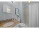 Bathroom offers a shower, granite vanity, framed mirror and modern fixtures for a comfortable and efficient space at 3007 Appling Way, Durham, NC 27703