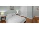 Bright bedroom features wood floors, neutral walls, and a white bedspread, creating a serene and inviting space at 3007 Appling Way, Durham, NC 27703