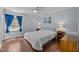 Bedroom has hardwood floors, ceiling fan, and a bright window, complete with cozy furnishings and side tables at 3007 Appling Way, Durham, NC 27703