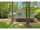 Charming single-Gathering home with green shutters surrounded by mature trees and landscaping at 3007 Appling Way, Durham, NC 27703