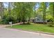 Charming single-Gathering home with green shutters surrounded by mature trees and landscaping at 3007 Appling Way, Durham, NC 27703