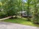 Charming single-Gathering home with green shutters surrounded by mature trees and landscaping at 3007 Appling Way, Durham, NC 27703