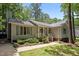 Charming single-Gathering home with green shutters surrounded by mature trees and landscaping at 3007 Appling Way, Durham, NC 27703