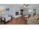 Bright living room with painted brick fireplace, ceiling fan, and neutral decor at 3007 Appling Way, Durham, NC 27703